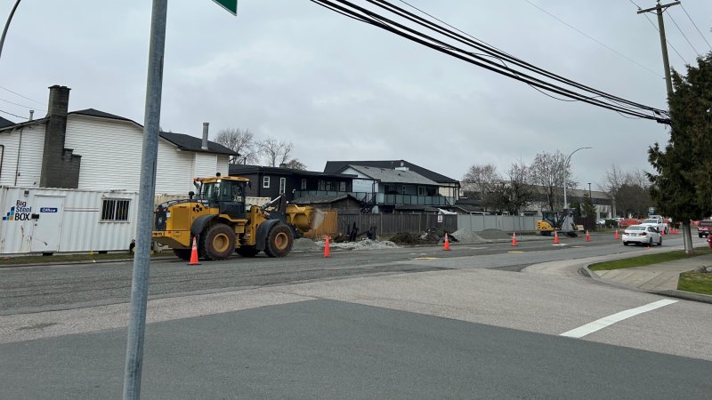 Street sign for Comber Way and 132 St with road construction in the background.