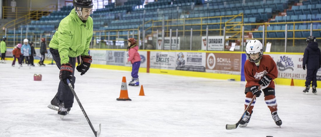 Two people playing hockey.
