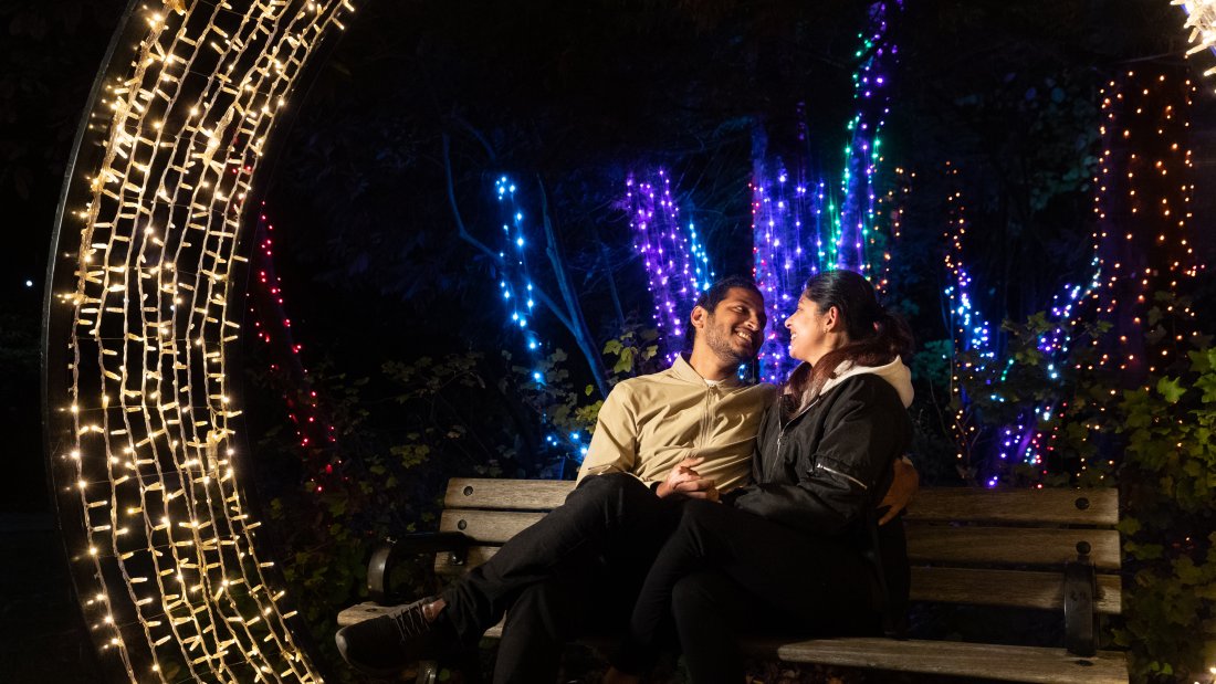 couple smiles at each other under archway