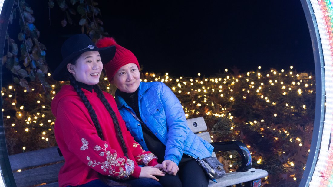 mother and daughter pose for photo on bench