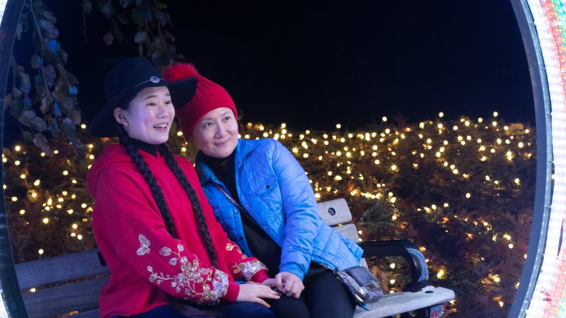 mother and daughter pose for photo on bench