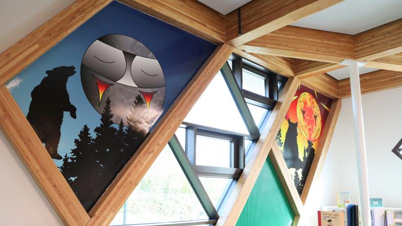 An indigenous moon and sun on the walls of a library 