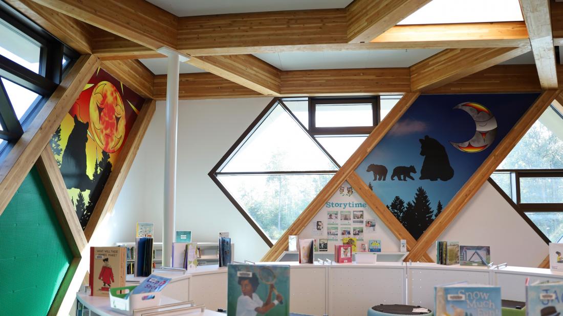 An indigenous moon and sun on the walls of a library 