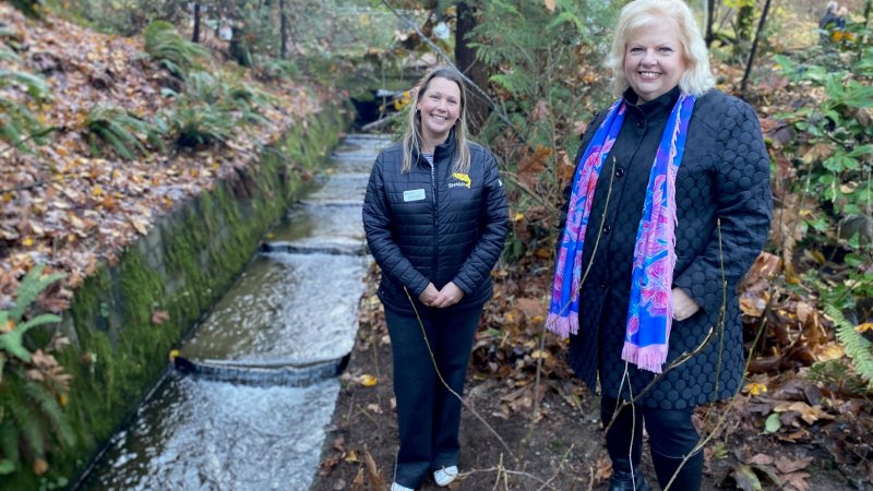 Mayor Brenda Locke and SHARP staff member standing next to stream