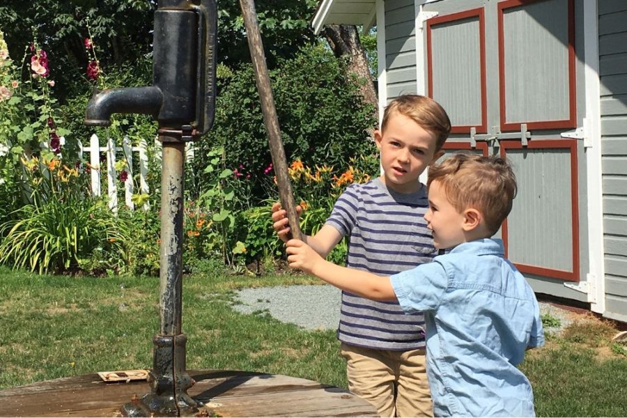 Two boys using the waterpump
