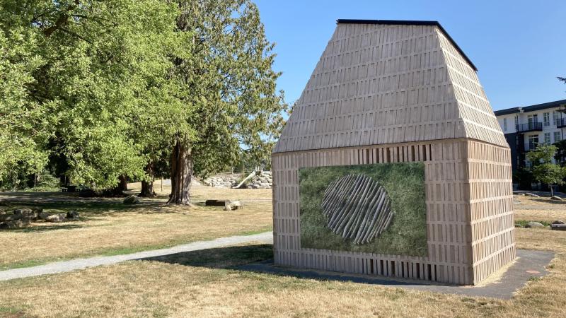 A small building with public art Branch Round on one wall