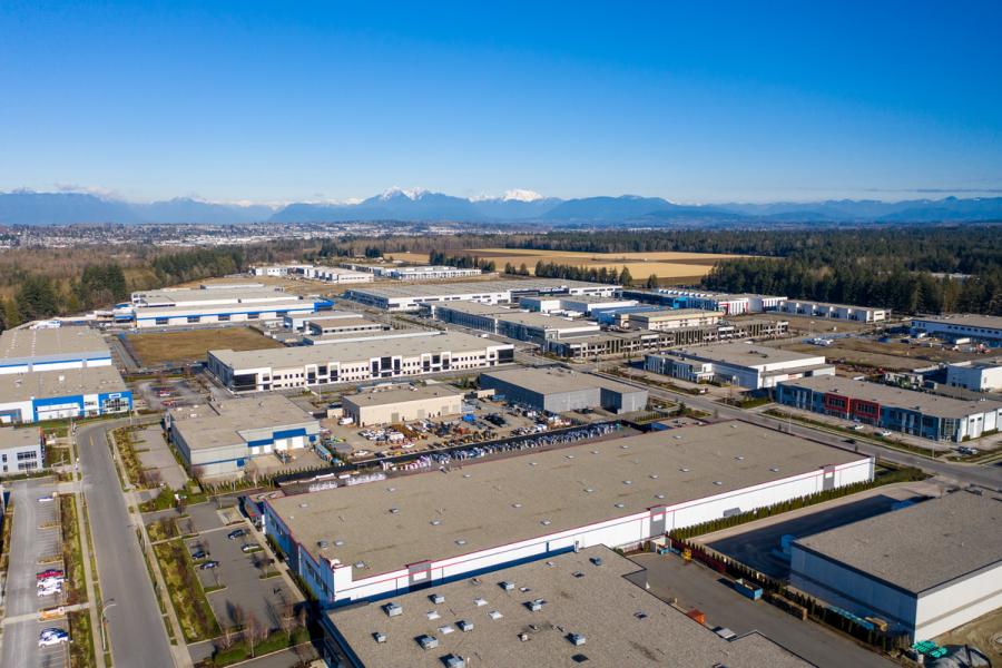 Mountains and blue sky with industrial buildings below