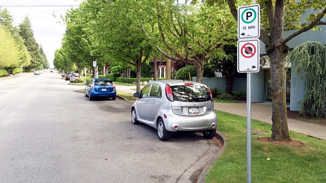 Car parked on the street with signs