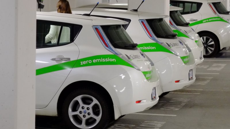 row of parked electric cars in parkade