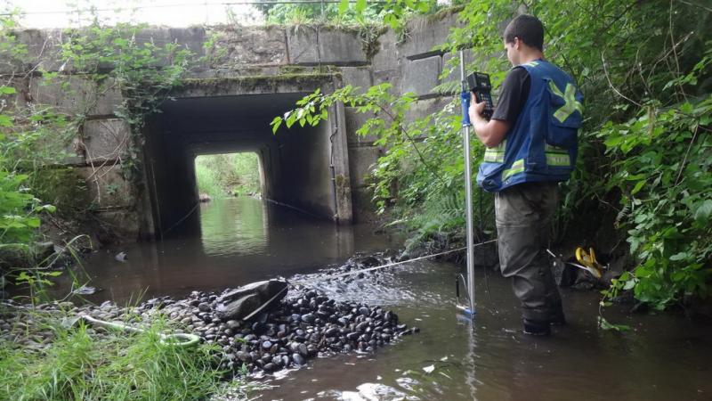 Surrey worker monitoring water flow.