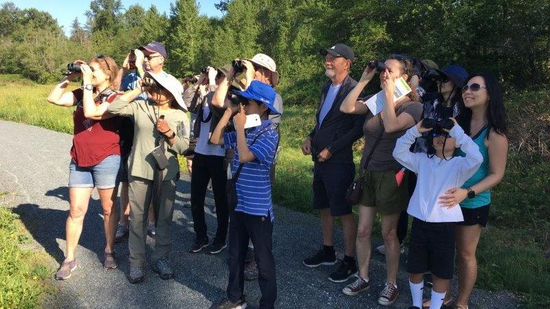 Surrey residents using binoculars to observe wildlife at an Environmental Extravanganza event