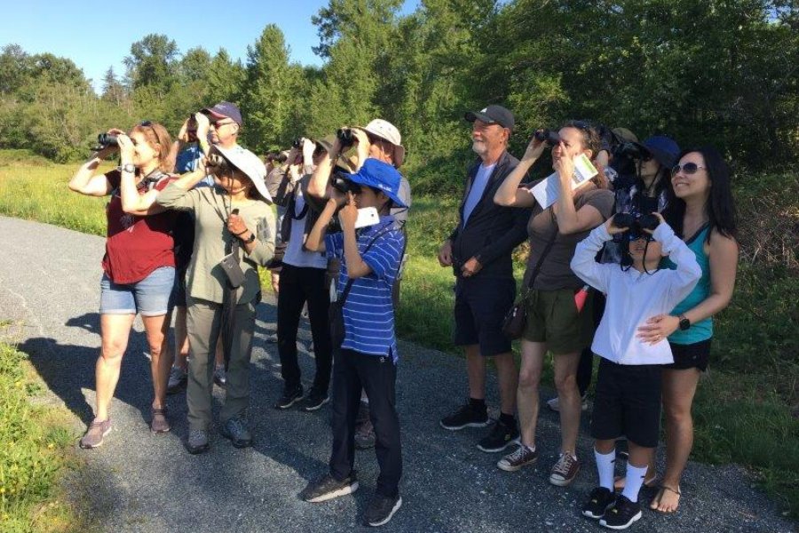 Surrey residents using binoculars to observe wildlife at an Environmental Extravanganza event