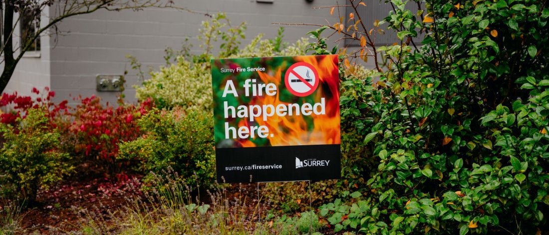 A fire happened here sign in a garden