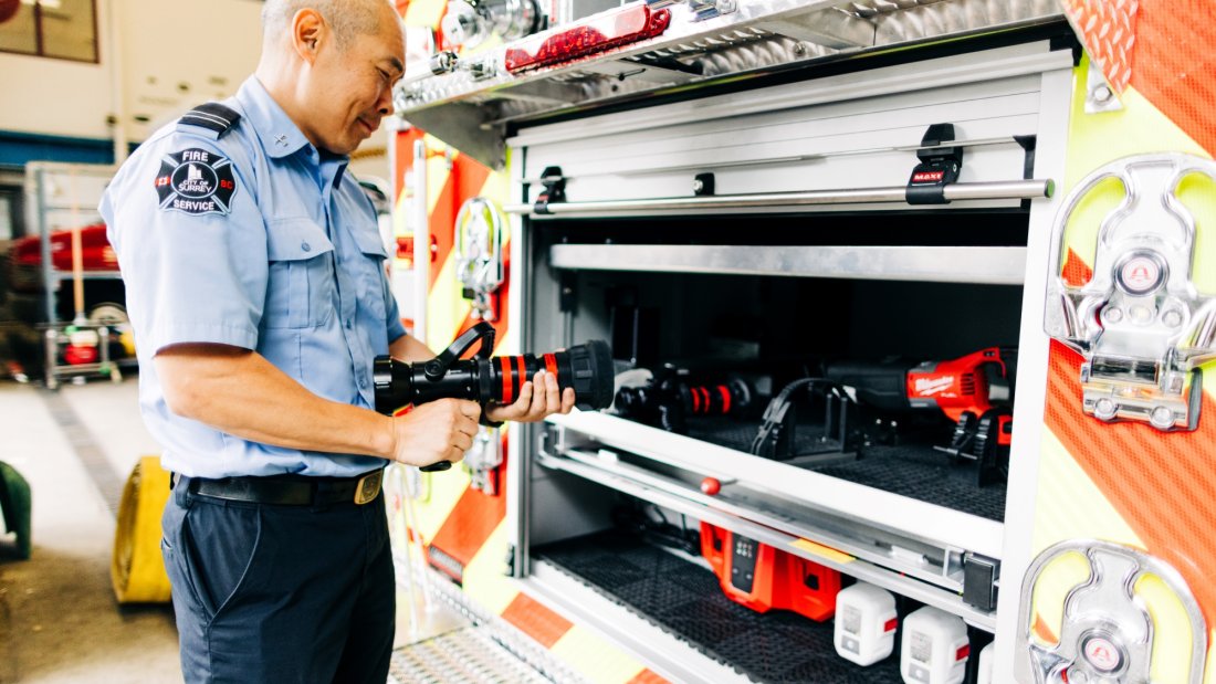 firefighter inspects tools