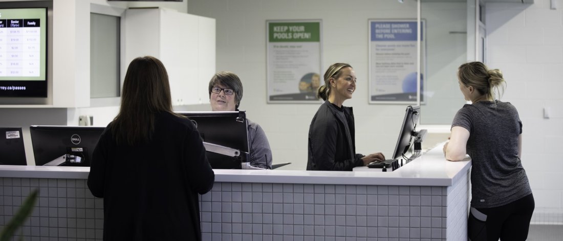 Four people at a front desk.