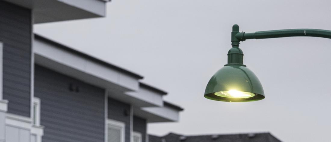A street light hangs over a path