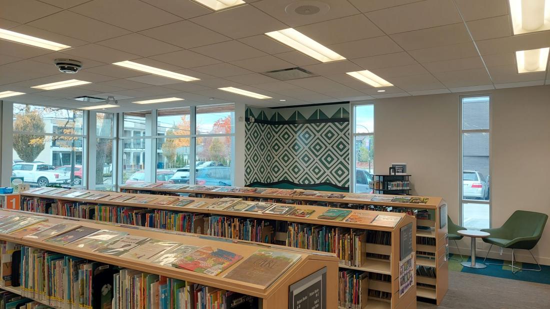 Green and white triangular artwork in the corner of a library