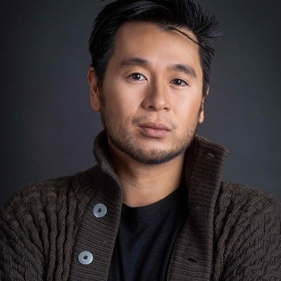 Headshot of Kevin Takahide Lee, music director for the Re-Enactors.