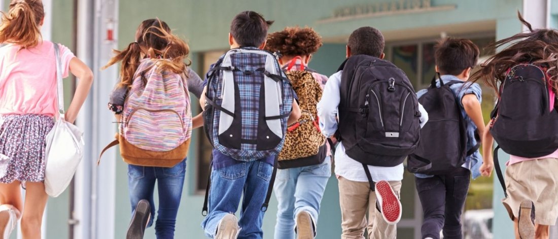 Kids running with their backpacks