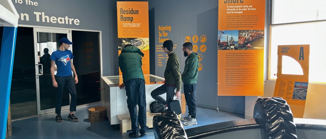 Four kids looking at a museum exhibit.