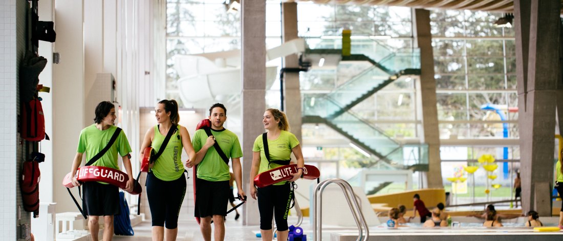 Lifeguards walking on the pool deck.