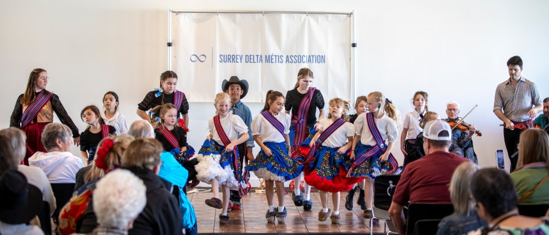 Attendees watching performances at the Metis: Children of the Fur Trade event