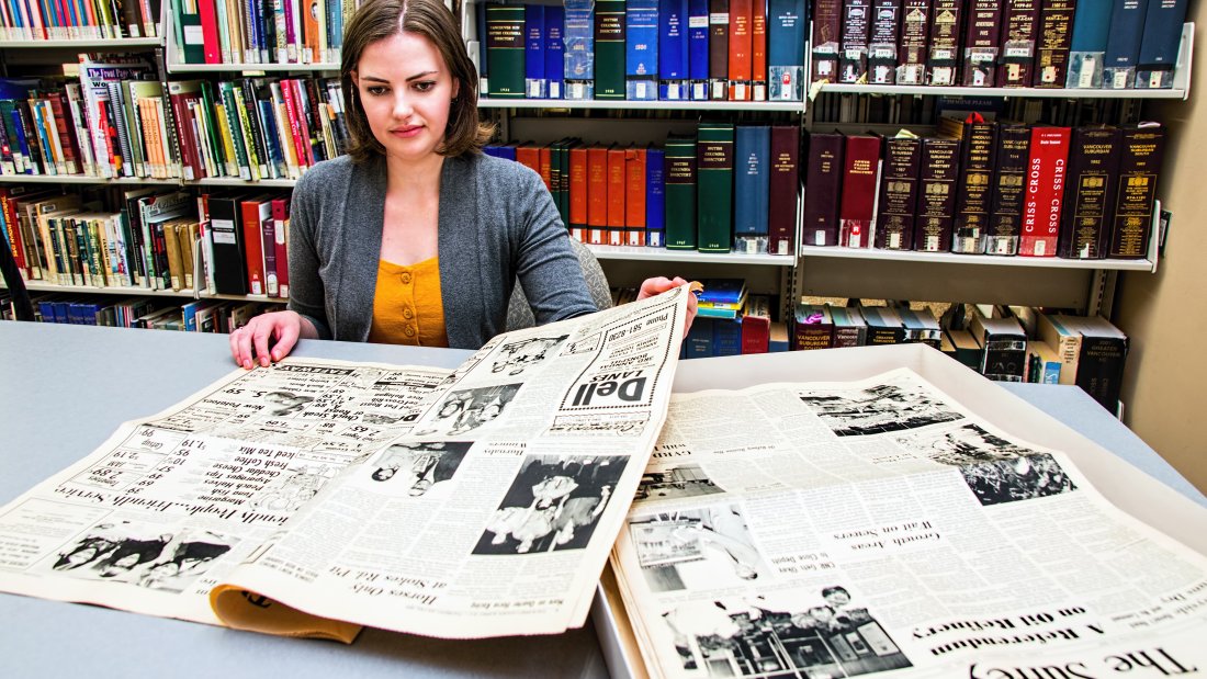 Woman looking at newspapers