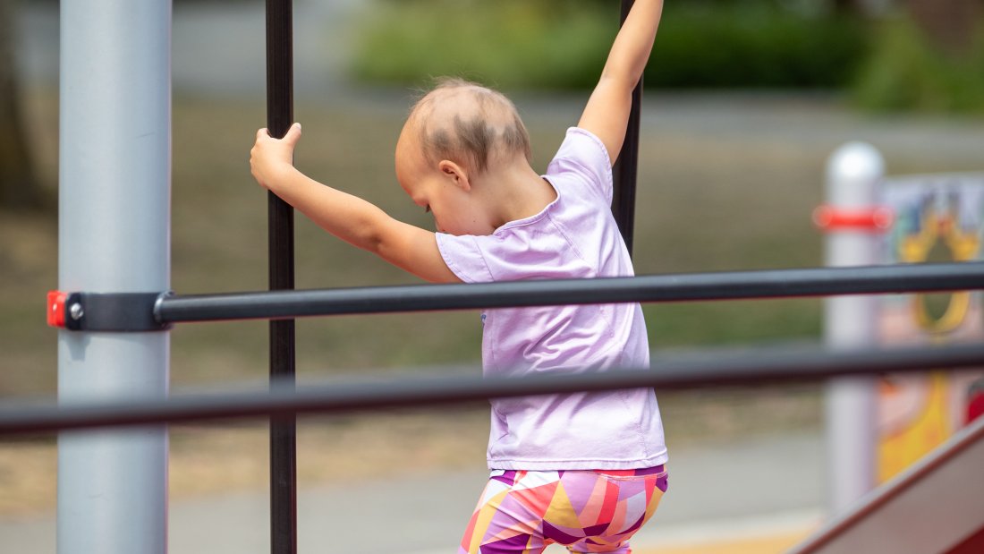 Girl plays on Unwin Parks accessible play elements.