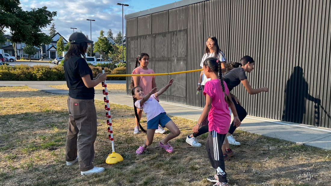 a group of children play limbo