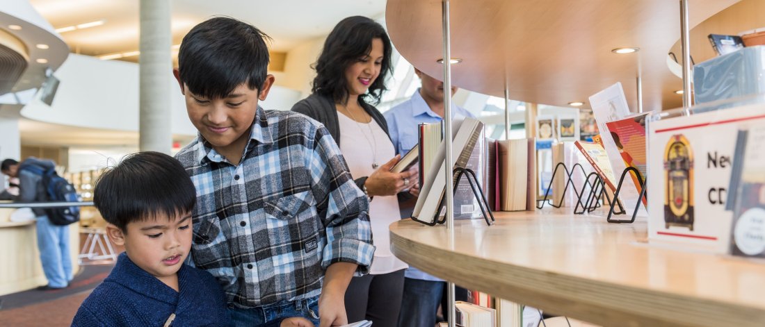 a family browses books at a Surrey library