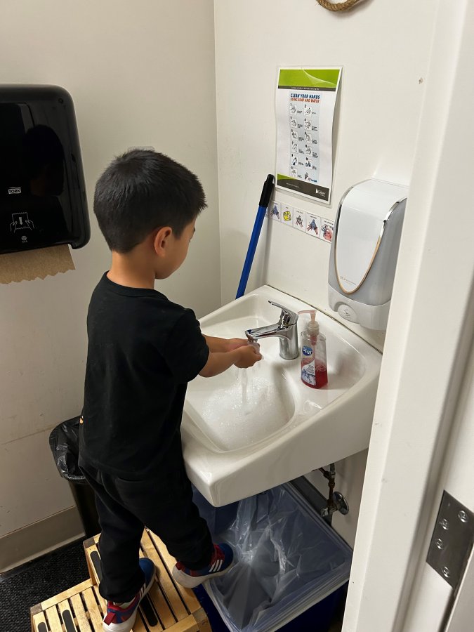 child washing hands