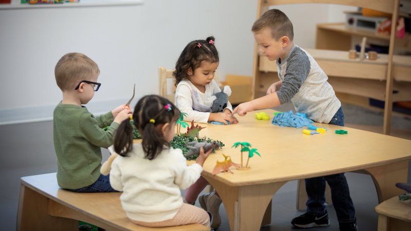 A group of children at preschool, playing together. 