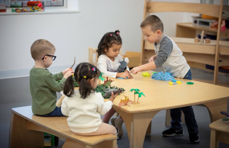 A group of children at preschool, playing together. 