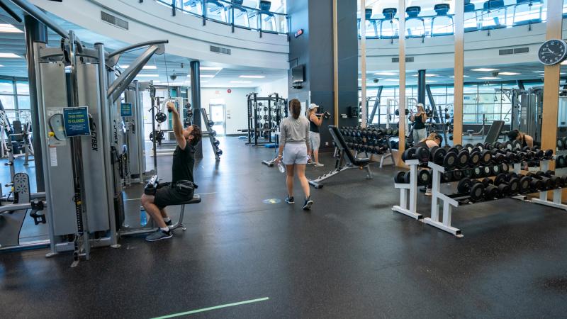 People working out at the gym physically distanced.
