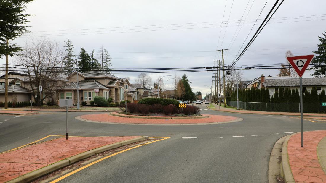 roundabout with raised splitter islands and a yield sign
