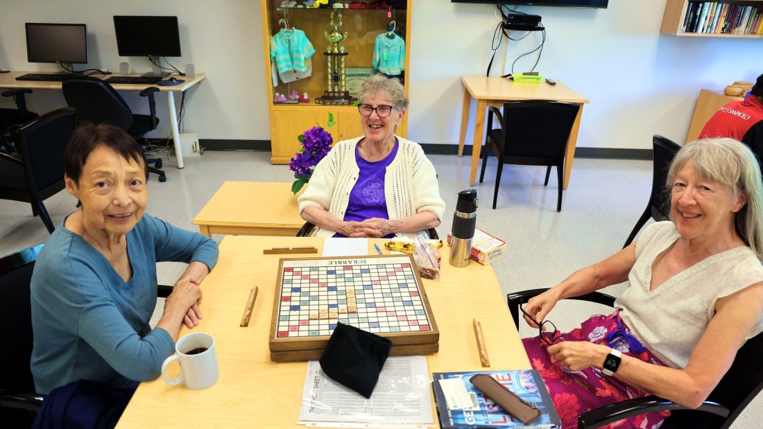 three seniors playing scrabble