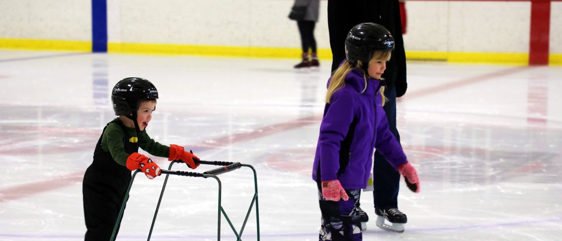 A young boy and girl skating.