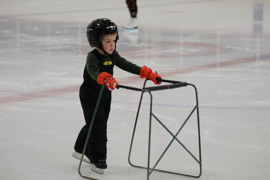 A little boy skating.