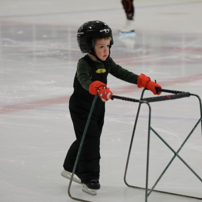 A little boy skating.