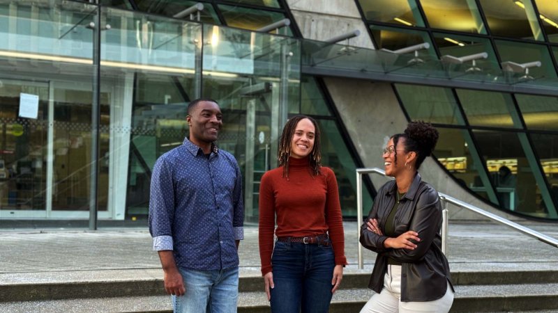 Three individuals outside a building
