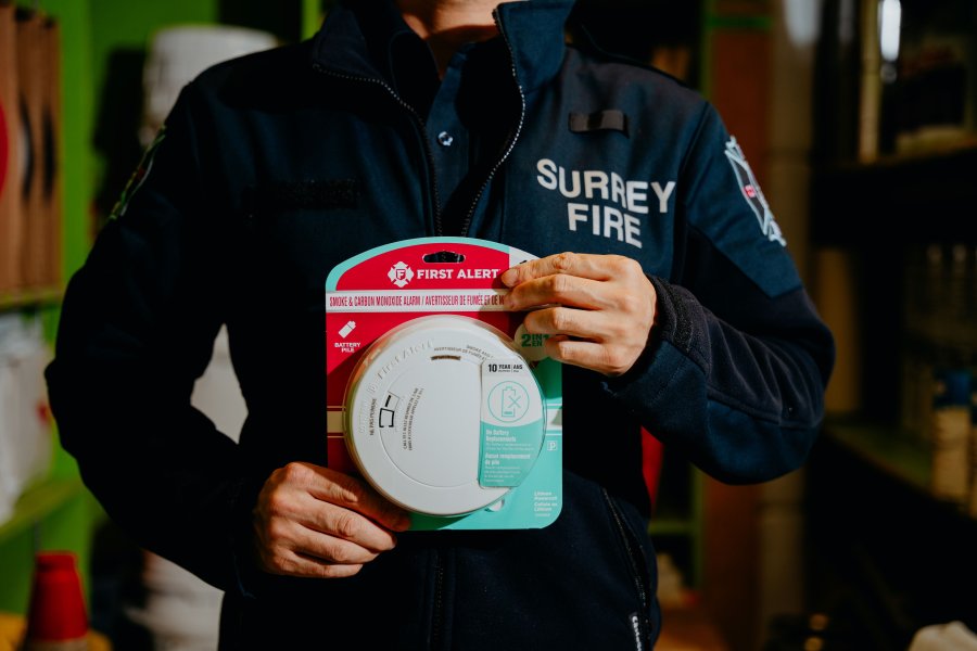 Staff holding smoke alarm