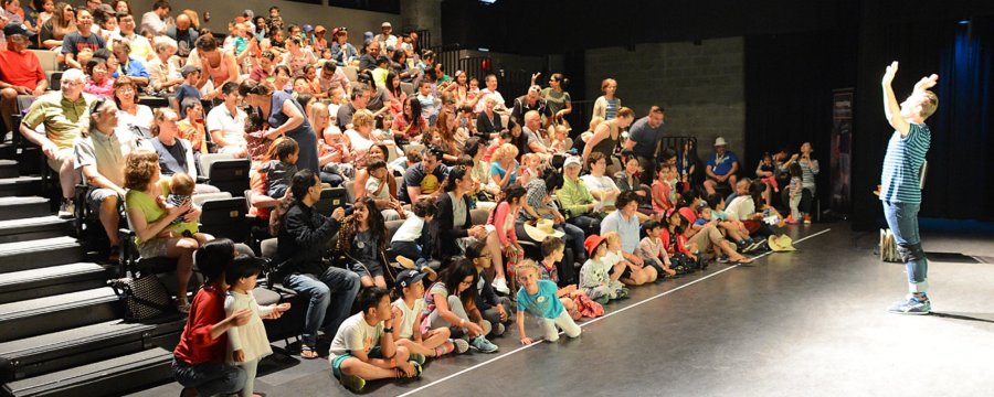 performer standing in front of an audience in Studio Theatre 