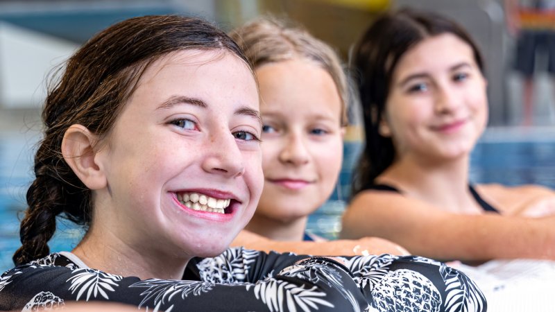 Girls swimming in the pool.