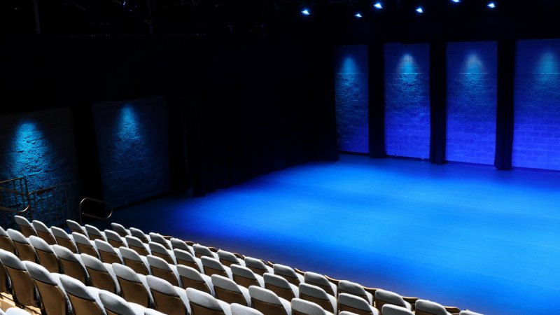 studio theatre at surrey arts centre with seating pulled out and blue lighting