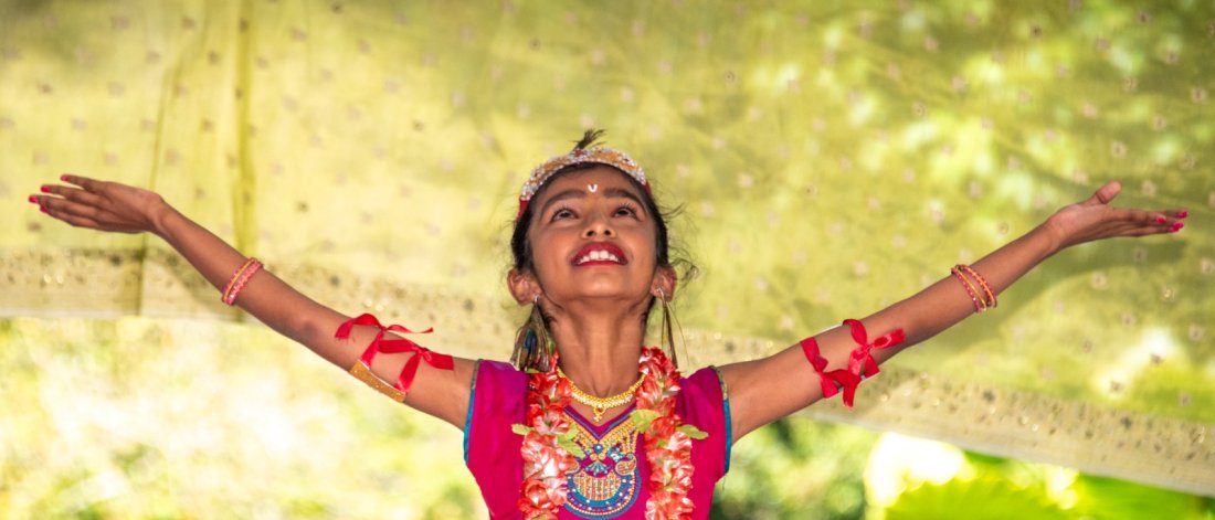 a woman in cultural dress performing at an event