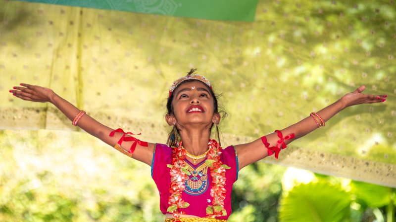 a woman in cultural dress performing at an event