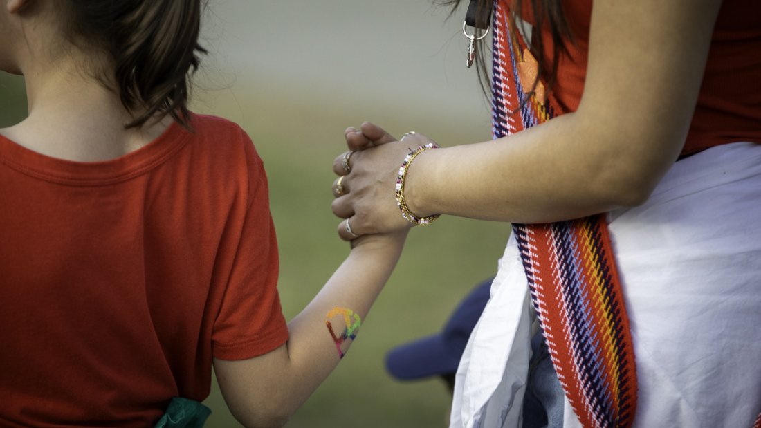a mother and daughter holding hands while participating at NIPD