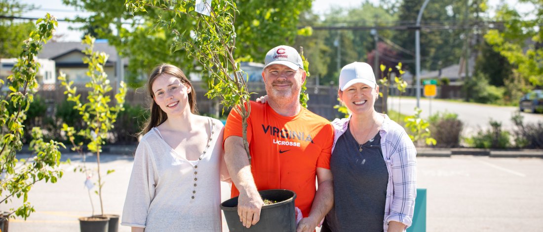 a family picking up a tree at the Surrey Tree sale