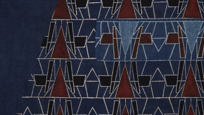 A pattern of geometric shapes including red triangles and black squares. The pattern is not uniform but has some slight irregularities.
