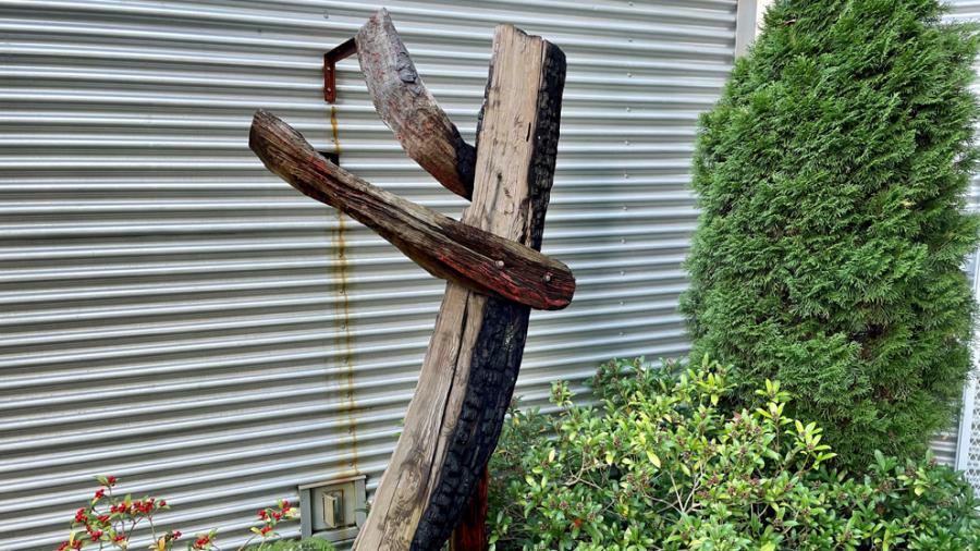 3 pieces of deadwood are arranged to look like a figure holding out arms